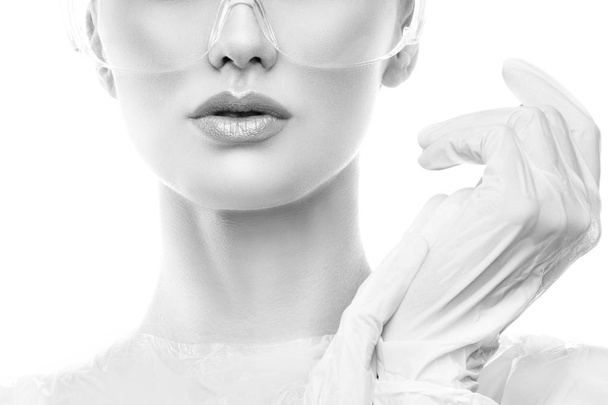 Ritratto ritagliato di giovane donna con trucco naturale in eye-shield e guanti chirurgici
  - Foto, immagini