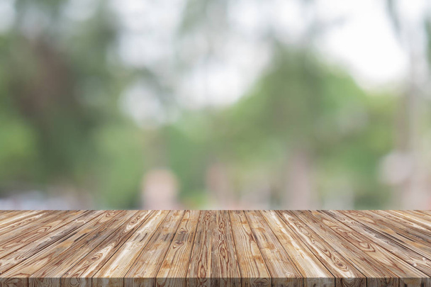 Empty wood table top on green blur background at garden - 写真・画像