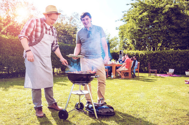 Group of friends having outdoor garden barbecue  - Zdjęcie, obraz