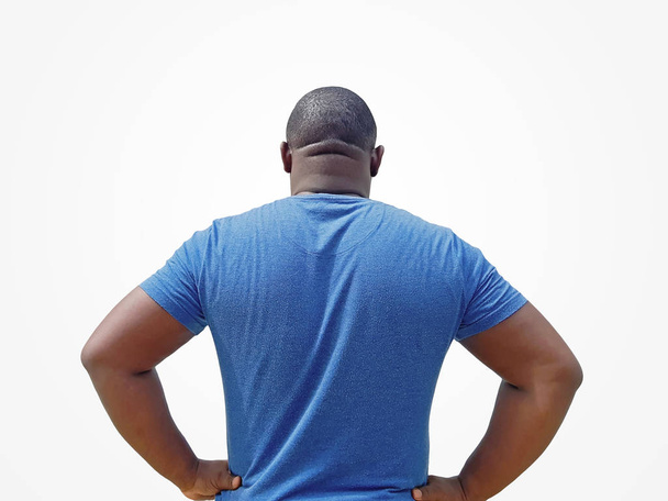 Rear view of man standing confidently with his hands on his waist, arms akimbo. - Photo, Image