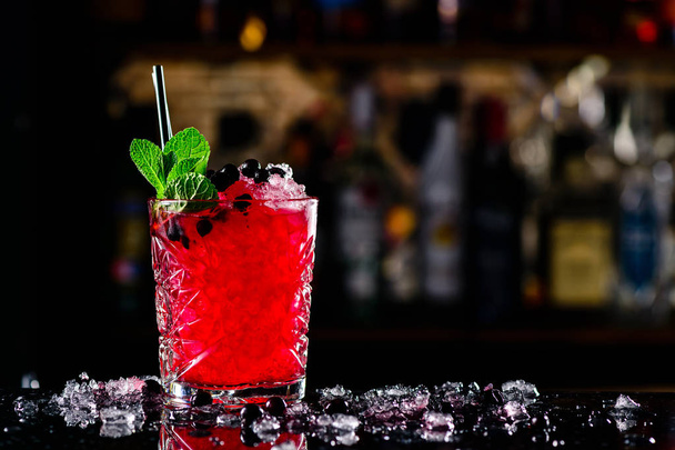blackcurrant cocktail with ice on forward bar background - 写真・画像