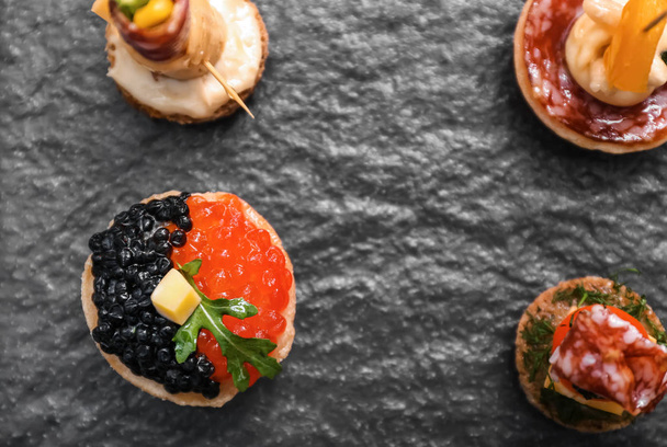 Tasty canapes on slate plate - Photo, Image