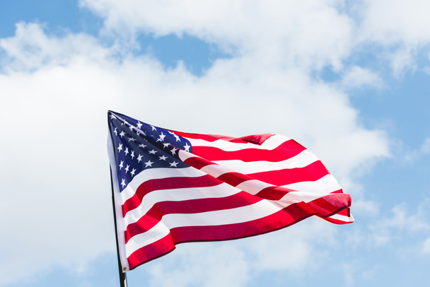 low angle view of flag with stars and stripes against blue sky - Fotó, kép