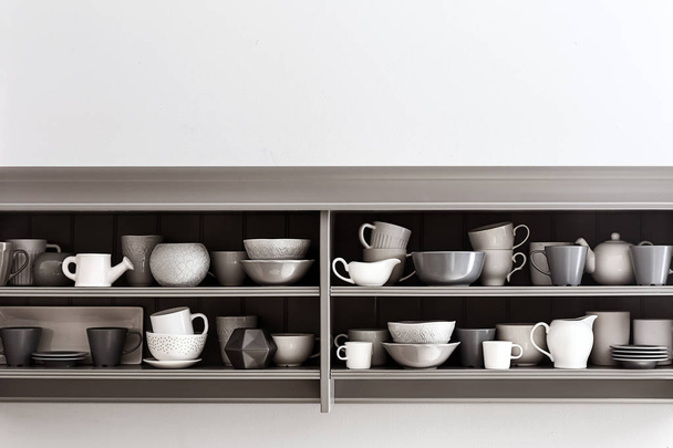Shelves with clean dishes on white background - Photo, Image
