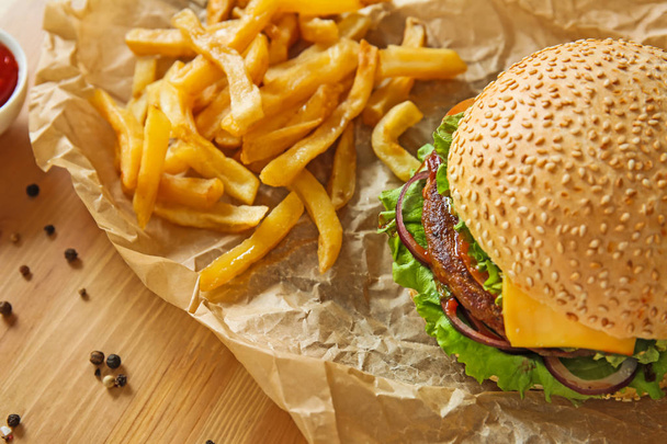 Tasty fresh burger and french fries on table - Photo, Image