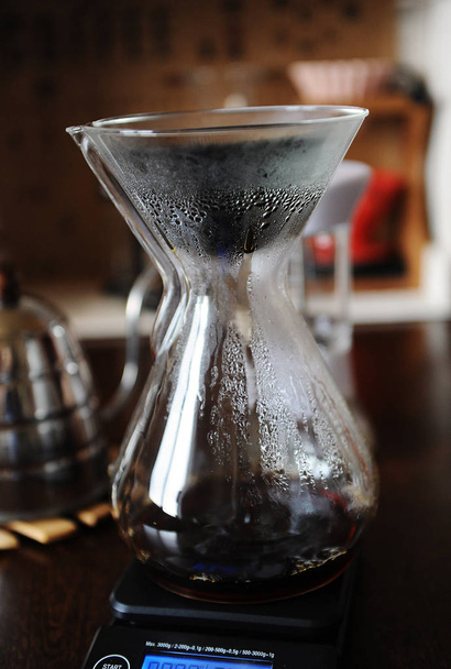 Black japonic porous ceramic paperless dripper filter in glass jug. Alternative manual coffee brewing. Gooseneck kettle - Φωτογραφία, εικόνα