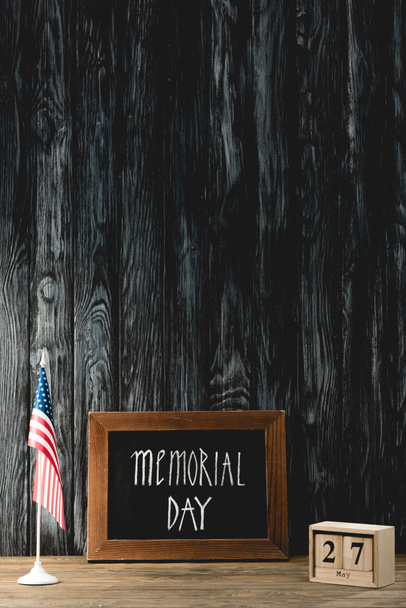 chalkboard with memorial day lettering near american flag and cubes with date - Fotó, kép