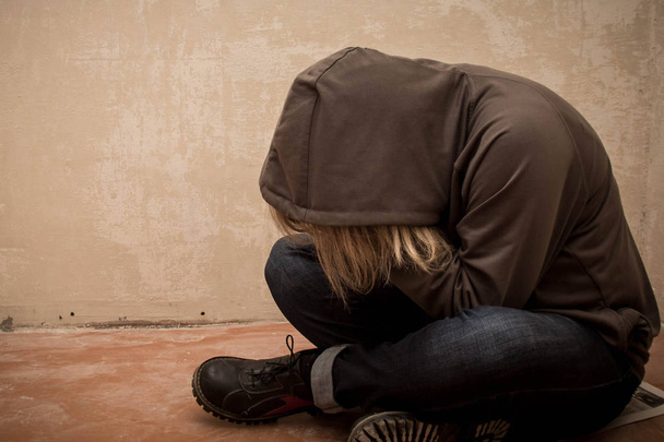 Portrait of man sad, drug addict man sitting on the floor in corner - Photo, Image
