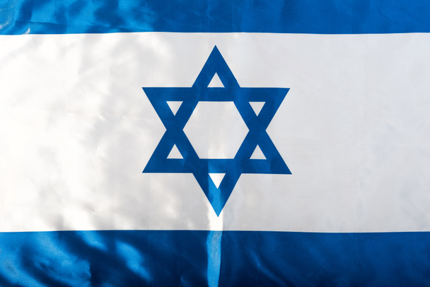 close up of national israel flag with blue star of david  - Zdjęcie, obraz