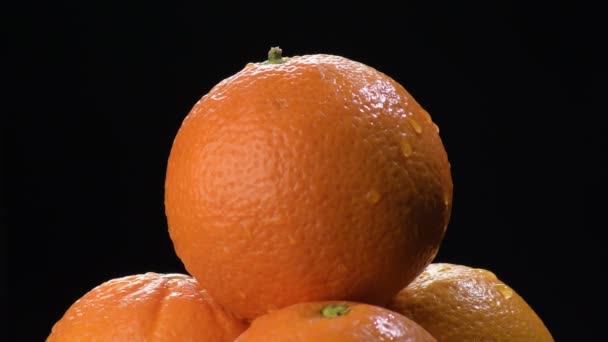 Giro de fruta naranja fresca sobre fondo negro
 - Metraje, vídeo