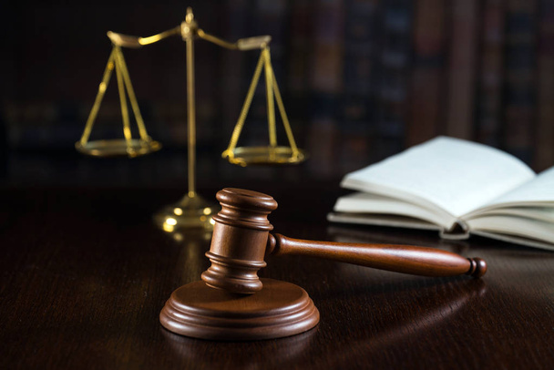 Huge judge's wooden gavel on blurred background - 写真・画像