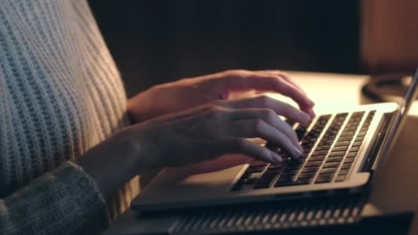 Hands of woman working on laptop in dark room. Close up. - Video