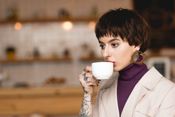 pensive, fashionable businesswoman drinking coffee from white coffee cup - Photo, Image