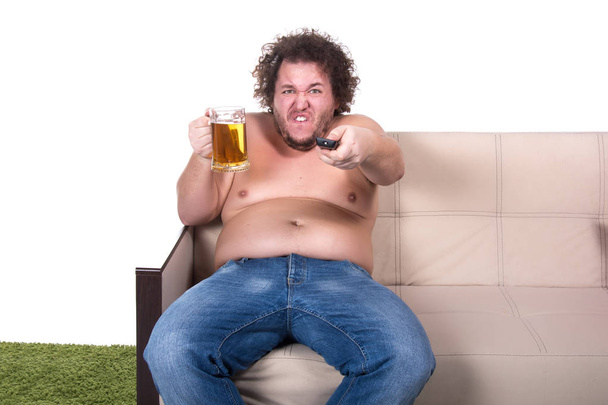 Funny fat man watching tv at home. - Photo, Image