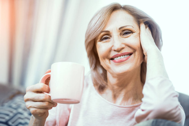 A Woman Over 50 Years of European Appearance Resting at Home Drinking Tea. - Φωτογραφία, εικόνα
