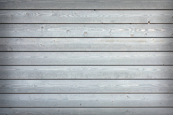 horizontal wooden planks with grey paint on fence - Foto, Bild