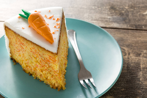 Sweet carrot cake slice on wooden table. - Photo, Image