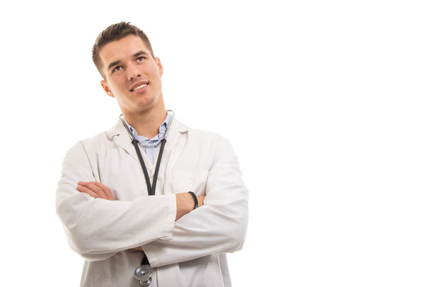 Portrait of young handsome doctor standing with arms crossed - Foto, Imagem