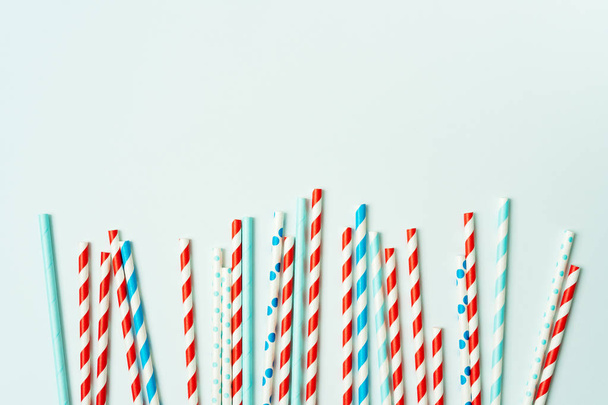 Pile of drinking straws for beverage on pastel blue background - Zdjęcie, obraz