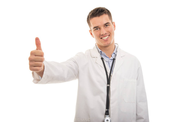 Portrait of young handsome doctor showing like gesture - Foto, Imagen