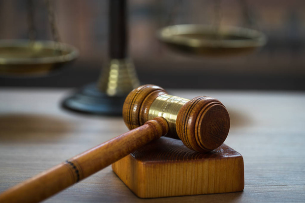 Huge judge's wooden gavel on blurred background - 写真・画像