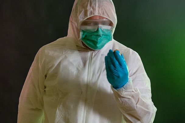 Man in chemical suit inspecting possible toxic materials - Fotó, kép