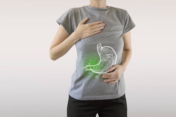 Digital composite of highlighted painful stomach of woman  - Fotografie, Obrázek