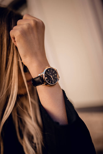 Stylish black watch on woman hand - Foto, immagini