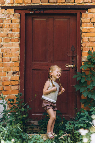 beautiful girl on the background of the door with the hair raised from the wind - Fotografie, Obrázek