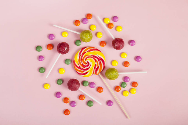 Colorful lollipops and different colored round candy. Top view. - Фото, зображення