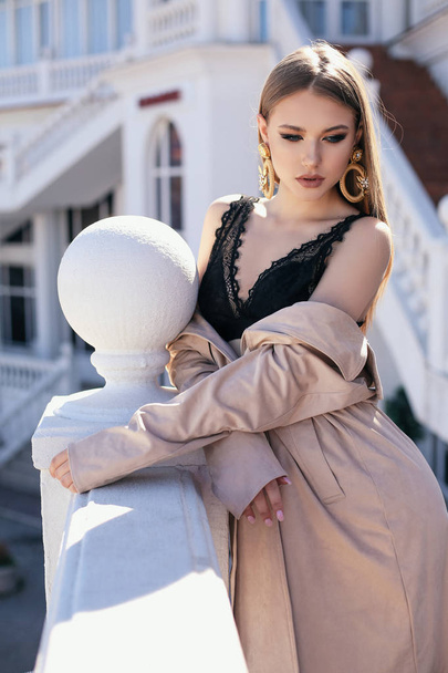 beautiful woman with blond hair in elegant outfit walking by the - Φωτογραφία, εικόνα