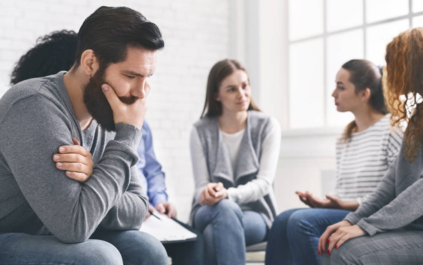 Depressed man sitting at rehab group therapy - Photo, Image
