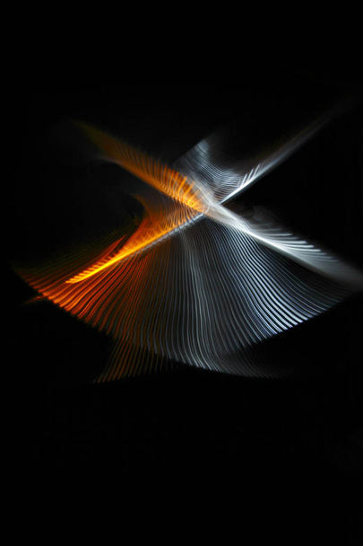 Multicolored twisted ordered parallel lines on a black background. Light in motion. Color abstraction. - Photo, image
