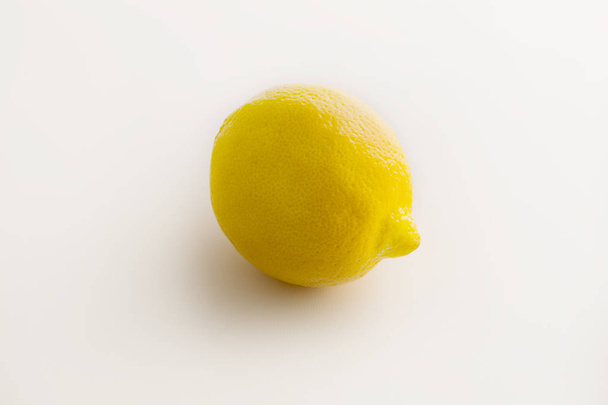 Yellow lemon on the white background - Valokuva, kuva