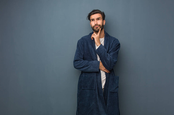 Man wearing pajama doubting and confused - Fotoğraf, Görsel
