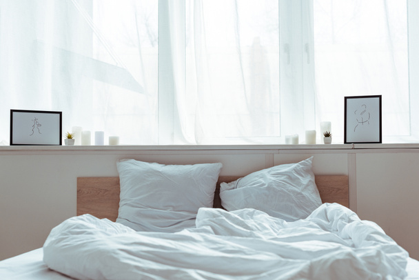 camera da letto moderna con letto accogliente, cuscini, coperta, immagini di giorno
  - Foto, immagini