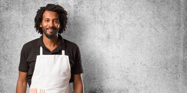 Handsome african american baker cheerful and with a big smile, confident, friendly and sincere, expressing positivity and success - Photo, Image