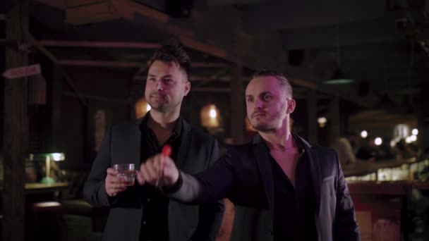 zwei Männer in Anzügen trinken Whisky in einer Bar - Filmmaterial, Video