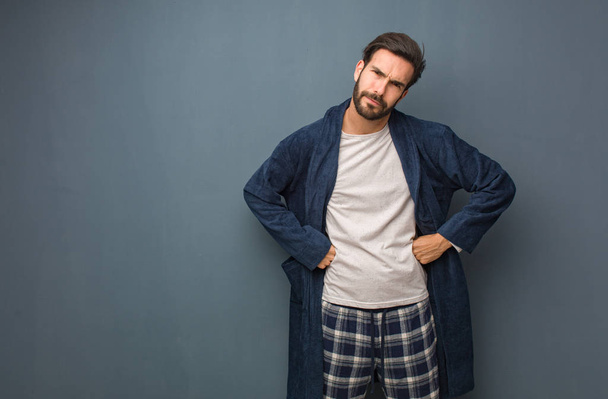 Man wearing pajama scolding someone very angry - Foto, afbeelding