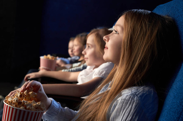 Children watching movie in cinema theatre. - Фото, зображення
