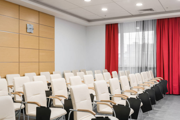 Empty modern conference hall in new hotel. Room for training, education, group classes, exams. Audience for Speakers at Business convention and Presentation. - Photo, Image
