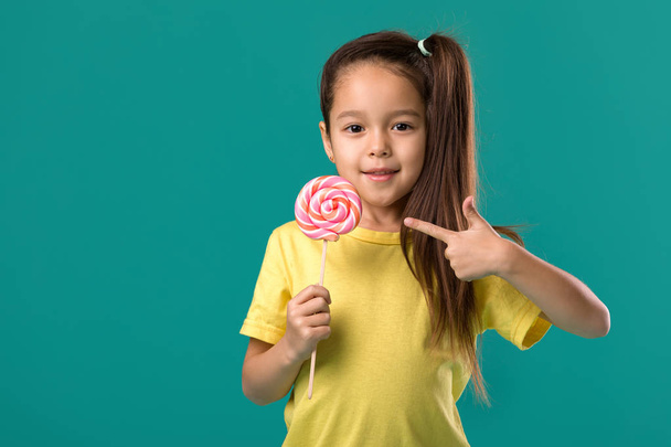 Beautiful cute little girl with a lollipop - Fotó, kép