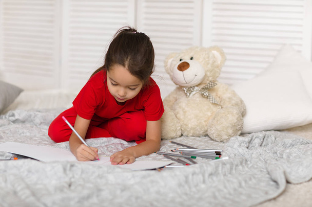 little child girl draws with pencils at home - Valokuva, kuva