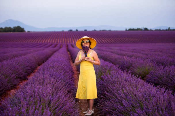 asian woman in yellow dress and hat at lavender field - Фото, зображення