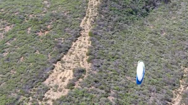 Para-glider over the top of the mountain during summer sunny day. Para-glider on the para-plane, strops -soaring flight moment flying over Black Mountain in San Diego, California. USA - Footage, Video