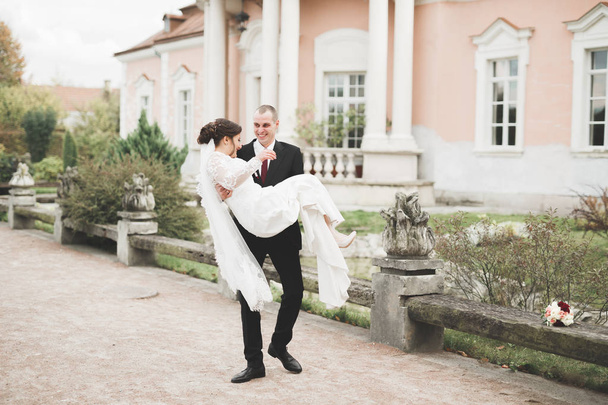 Amazing happy gentle stylish beautiful romantic caucasian couple on the background ancient baroque castle - Foto, Imagem