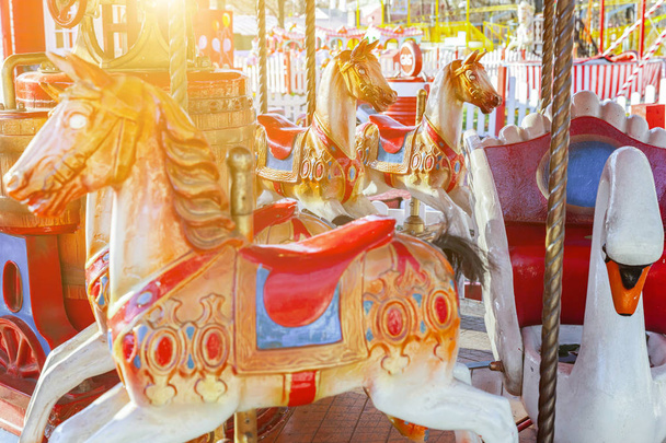 Vintage Merry-Go-Round flying horse carousel in amusement holliday park - Foto, Imagen