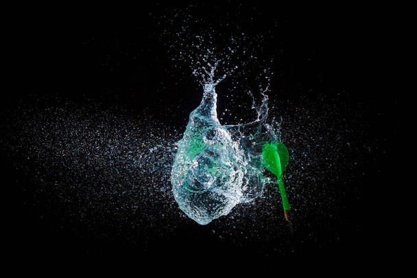Amazing explosion big water color balloon bomb with splash  water on isolated  black background with flash. concept of freezing moment of time. - Foto, Bild
