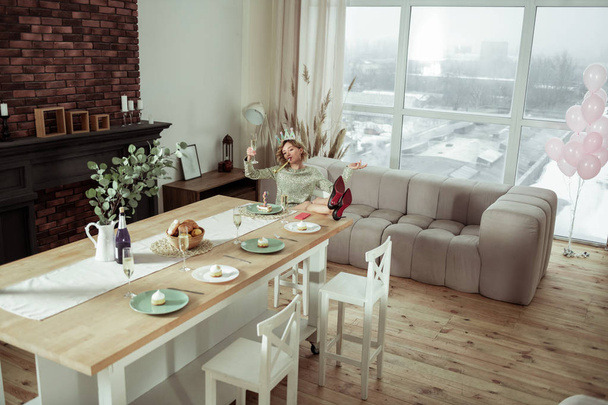 Woman staying alone in spacious apartment on birthday - Photo, Image