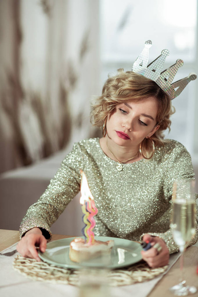 Blonde woman wearing dress and queen crown feeling depressed - Фото, изображение
